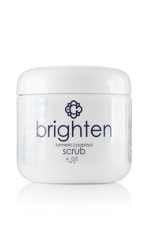 Jar of Candee Skin Brand 'brighten' turmeric papaya scrub on a white background